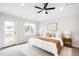 Comfortable main bedroom featuring natural light, soft carpet, overhead fan, and stylish furniture at 4730 S Acoma St, Englewood, CO 80110