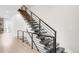 Modern staircase with black metal railings and dark wood steps, leading to the upper floors at 4730 S Acoma St, Englewood, CO 80110