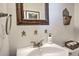 Close up of powder room featuring a white basin sink, unique mirror, and decorative accents at 532 Kimmes Ln, Breckenridge, CO 80424