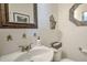 Powder room featuring a white basin sink, unique mirror, and decorative accents at 532 Kimmes Ln, Breckenridge, CO 80424