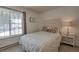 Cozy bedroom featuring a comfortable bed, side table with lamp, and a window view of snowy landscapes at 532 Kimmes Ln, Breckenridge, CO 80424