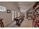 Spacious bonus room with a shuffleboard table, bunk beds, and natural light at 532 Kimmes Ln, Breckenridge, CO 80424