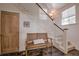 Inviting entryway features slate flooring, a wooden bench, and a staircase to the upper level at 532 Kimmes Ln, Breckenridge, CO 80424