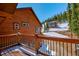 Attractive exterior view with a balcony overlooking the snow covered street and mountain homes beyond at 532 Kimmes Ln, Breckenridge, CO 80424
