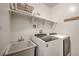 Well-lit laundry room with modern appliances, sink, and ample storage shelves at 532 Kimmes Ln, Breckenridge, CO 80424