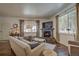 Cozy living room featuring a stone fireplace and large windows offering natural light at 532 Kimmes Ln, Breckenridge, CO 80424