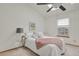 Bright bedroom with a vaulted ceiling, ceiling fan, and plush carpeting at 6742 S Independence St, Littleton, CO 80128