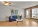 Comfortable living room with a blue sofa, hardwood floors, and natural light at 6742 S Independence St, Littleton, CO 80128
