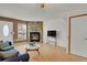 Bright living room featuring a stone fireplace, hardwood floors, and ample natural light at 6742 S Independence St, Littleton, CO 80128