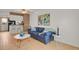 Cozy living room featuring stylish decor, a blue sofa, and hardwood floors at 6742 S Independence St, Littleton, CO 80128