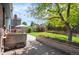 Landscaped backyard with brick patio, raised garden beds and mature trees, offering a private outdoor space at 11345 Marshall Ct, Westminster, CO 80020
