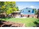 Spacious backyard with a well-maintained lawn, patio set, and a brick house with blue siding at 11345 Marshall Ct, Westminster, CO 80020