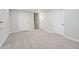 Finished basement with neutral carpet, base trim and white doors leading to storage spaces or rooms at 11345 Marshall Ct, Westminster, CO 80020