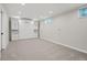 Spacious basement features a large carpeted area and a sleek, built-in Murphy bed with storage cabinets at 11345 Marshall Ct, Westminster, CO 80020