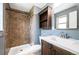 Bathroom featuring a walk-in shower, a built-in shelf, and a vanity with a sink at 11345 Marshall Ct, Westminster, CO 80020