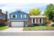 Charming two-story home featuring brick and siding, a well-maintained front yard, and a two-car garage at 11345 Marshall Ct, Westminster, CO 80020