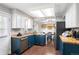 Bright kitchen with white upper cabinets, blue lower cabinets, stainless steel appliances, and wood countertops at 11345 Marshall Ct, Westminster, CO 80020