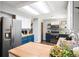 Open kitchen features a large island, butcher block countertops, stainless steel appliances, and ample cabinet space at 11345 Marshall Ct, Westminster, CO 80020