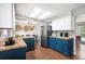 Updated kitchen featuring wood flooring, stainless steel appliances, and blue cabinets at 11345 Marshall Ct, Westminster, CO 80020