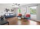 Bright living room featuring wood floors, large windows, stylish furniture, and contemporary decor at 11345 Marshall Ct, Westminster, CO 80020