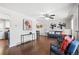 Open-concept living room seamlessly connects to the dining area, showcasing stylish furniture and wood flooring at 11345 Marshall Ct, Westminster, CO 80020