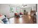 Cozy living room with hardwood floors, large windows, comfortable seating, and a staircase view at 11345 Marshall Ct, Westminster, CO 80020
