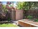 Backyard storage shed with landscaped garden, surrounded by trees and greenery, offering privacy and functionality at 11345 Marshall Ct, Westminster, CO 80020