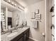Well-lit bathroom featuring granite counters, a double vanity, and plenty of counter space at 42729 Ivydel Cir, Elizabeth, CO 80107