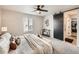 Bright bedroom with a sliding barn door to the ensuite, textured bedding, and neutral decor at 42729 Ivydel Cir, Elizabeth, CO 80107