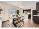 Dining area with a large table, bench seating, and view to the kitchen at 42729 Ivydel Cir, Elizabeth, CO 80107