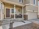 Inviting covered front porch with rocking chairs and stone accents at 42729 Ivydel Cir, Elizabeth, CO 80107