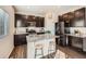 Modern kitchen with dark cabinets, granite countertops, and stainless steel appliances at 42729 Ivydel Cir, Elizabeth, CO 80107