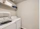Bright laundry room with modern washer and dryer and ample shelving for storage at 42729 Ivydel Cir, Elizabeth, CO 80107