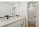 Bright bathroom featuring double sinks, quartz countertops, and black modern fixtures at 5439 Westin Hills Dr, Elizabeth, CO 80107