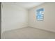Bright bedroom featuring white walls, carpeted flooring, a window with blinds, and base trim at 5439 Westin Hills Dr, Elizabeth, CO 80107