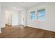 Bright living room boasts hardwood floors, white walls, large windows, and a glass paneled door at 5439 Westin Hills Dr, Elizabeth, CO 80107