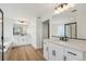 Luxurious bathroom with dual vanities, quartz countertops, soaking tub, glass-enclosed shower, and modern fixtures at 5439 Westin Hills Dr, Elizabeth, CO 80107