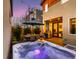 Backyard featuring a private hot tub, dining set, and outdoor kitchen setup at 3711 Mariposa St, Denver, CO 80211