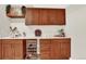 Stylish bar featuring wooden cabinetry, sleek countertops, and a wine fridge at 3711 Mariposa St, Denver, CO 80211
