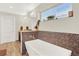 Bathroom boasts a soaking tub with decorative tile surround and fixtures offering a relaxing retreat at 3711 Mariposa St, Denver, CO 80211