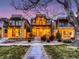 Charming three-story modern home with landscaped front yard at dusk at 3711 Mariposa St, Denver, CO 80211