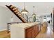 Open concept kitchen with island and stairs to the second floor at 3711 Mariposa St, Denver, CO 80211