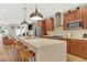 Stylish open kitchen with large island, modern pendant lights, and stainless steel appliances at 3711 Mariposa St, Denver, CO 80211