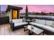 Chic rooftop deck with stylish seating, an umbrella, and cityscape views at 3711 Mariposa St, Denver, CO 80211