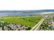 Scenic aerial view showcases community surrounded by greenery, roads, and a large body of water at 8544 S Upham Way, Littleton, CO 80128