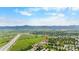 Wide aerial shot showcases the community and nearby mountains and highways at 8544 S Upham Way, Littleton, CO 80128