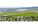 Expansive aerial view features the neighborhood and the lake views in the distance at 8544 S Upham Way, Littleton, CO 80128