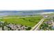 Picturesque aerial view of property with green spaces, roads, and distant lake at 8544 S Upham Way, Littleton, CO 80128