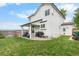 Backyard view of a white house featuring a lawn, patio, outdoor furniture, and grill at 8544 S Upham Way, Littleton, CO 80128