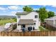 Private fenced backyard with patio seating, grills, and grassy area at 8544 S Upham Way, Littleton, CO 80128